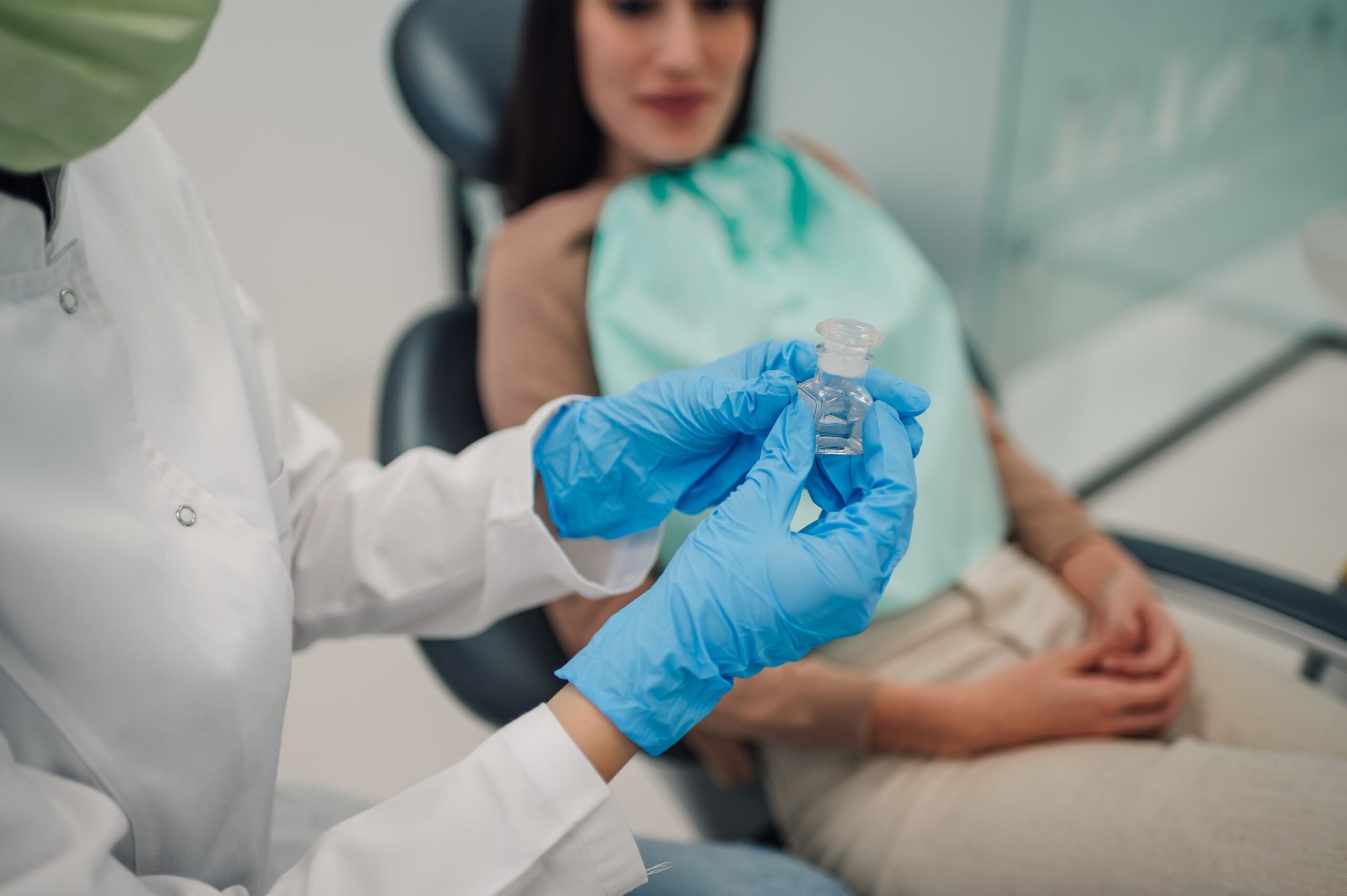 dentist-holding-small-bottle